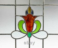 Art Nouveau-style floral leaded stained glass window panel