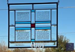 Stained glass panel, ruby red jewel, sky blue accents, and bevels, 12.5 x 11.5