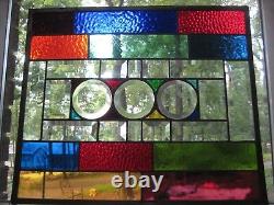 Stained glass panel with clear glass bevels and rainbow colors