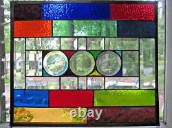 Stained glass panel with clear glass bevels and rainbow colors