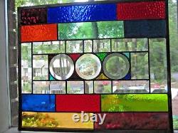 Stained glass panel with clear glass bevels and rainbow colors