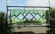 Stained glass window panel, featuring green and clear beveled sections, etched w