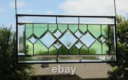 Stained glass window panel, featuring green and clear beveled sections, etched w