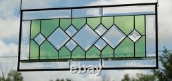 Stained glass window panel, featuring green and clear beveled sections, etched w