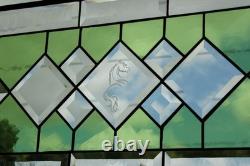 Stained glass window panel, featuring green and clear beveled sections, etched w