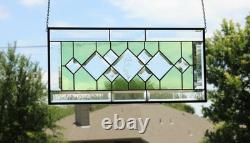 Stained glass window panel, featuring green and clear beveled sections, etched w