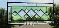 Stained glass window panel, featuring green and clear beveled sections, etched w