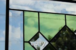 Stained glass window panel, featuring green and clear beveled sections, etched w