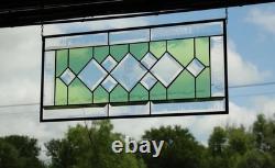 Stained glass window panel, featuring green and clear beveled sections, etched w