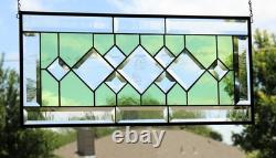 Stained glass window panel, featuring green and clear beveled sections, etched w