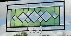 Stained glass window panel, featuring green and clear beveled sections, etched w