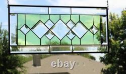 Stained glass window panel, featuring green and clear beveled sections, etched w