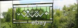 Stained glass window panel, featuring green and clear beveled sections, etched w