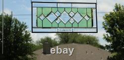 Stained glass window panel, featuring green and clear beveled sections, etched w